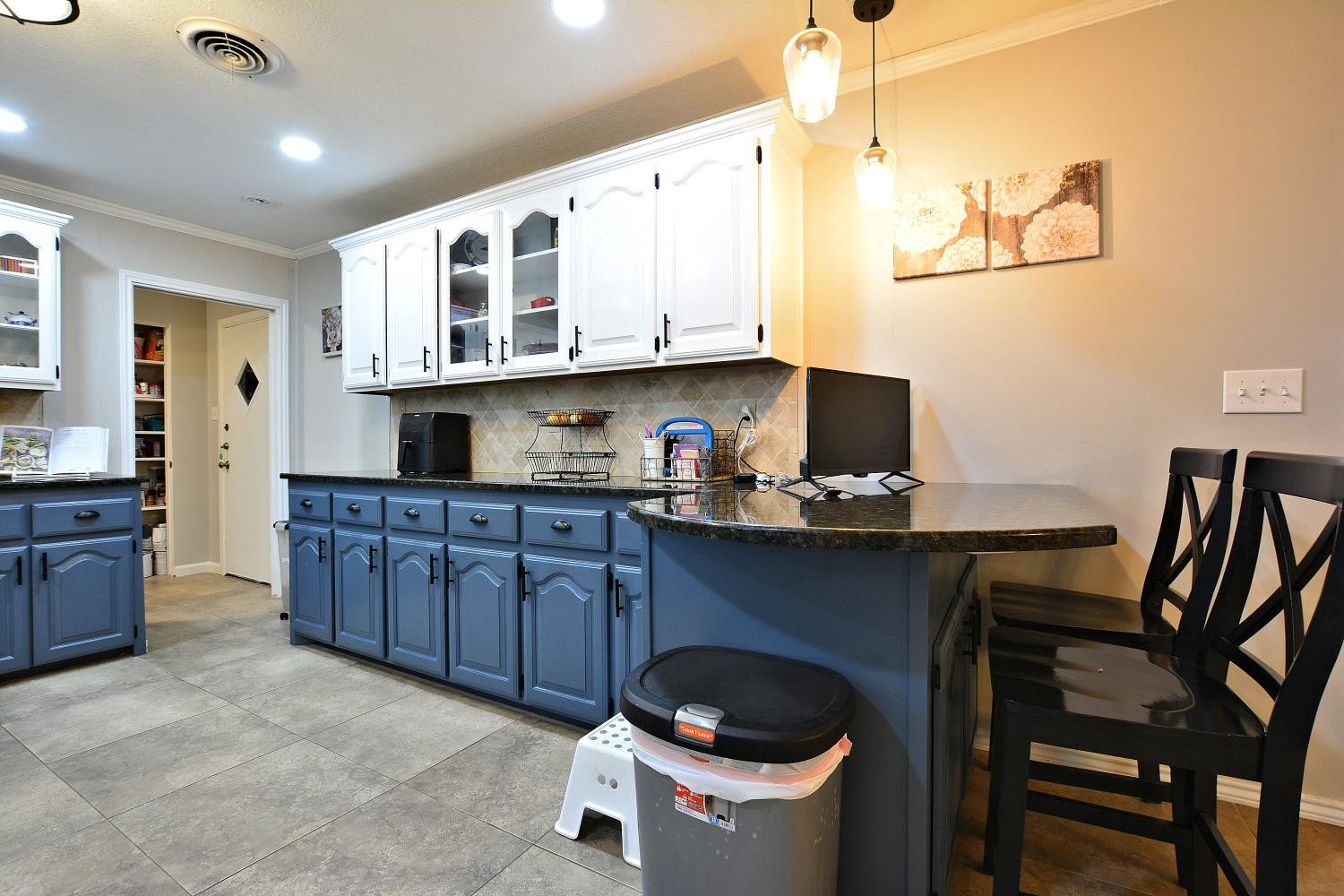 4903 17th Street Lubbock, TX 79416 - Photo 12 of 25 a kitchen with stainless steel appliances granite countertop a sink and cabinets