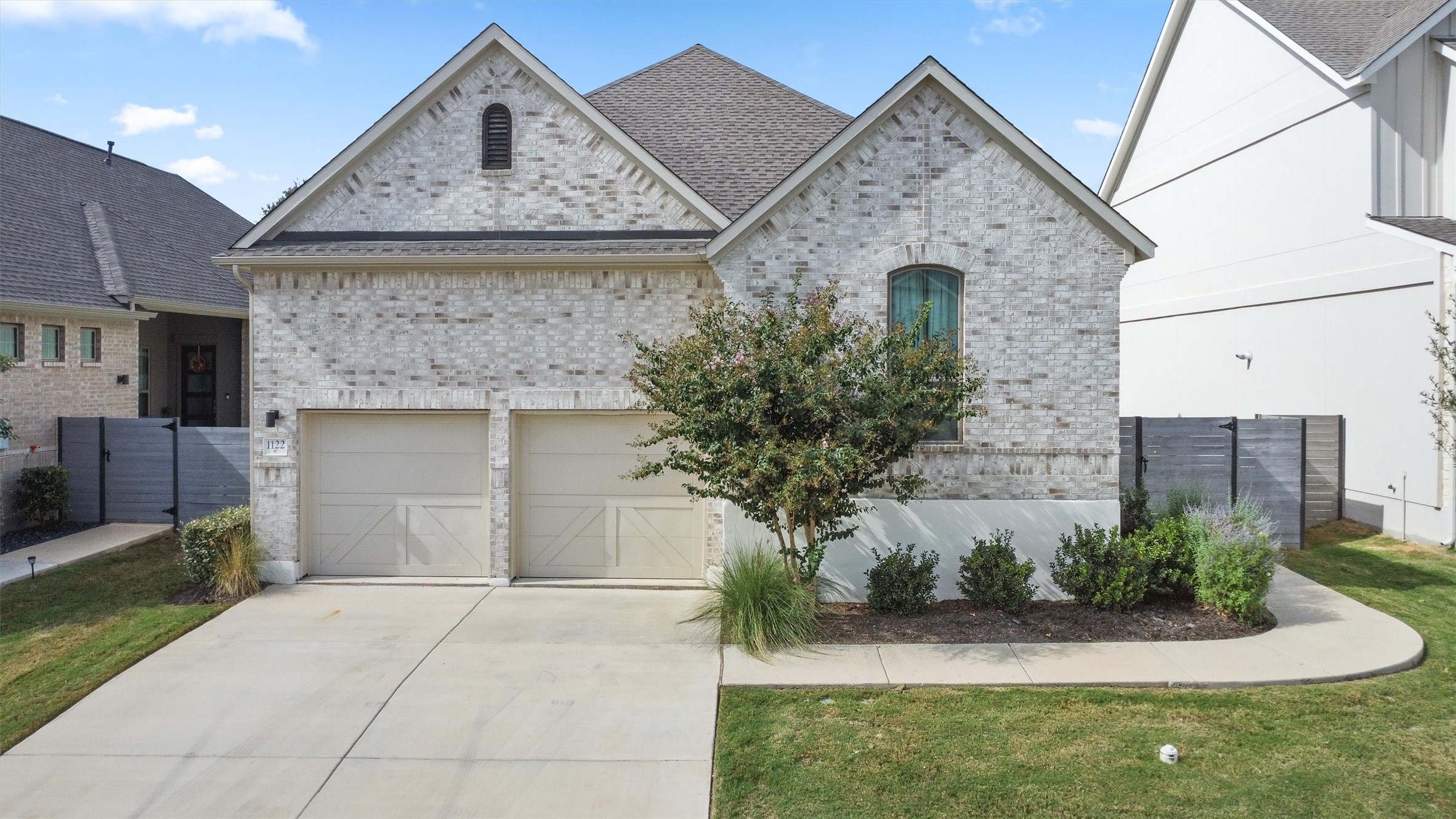1122 Silver Dollar Trail Georgetown, TX 78628 - Photo 1 of 35 a front view of a house with a garden
