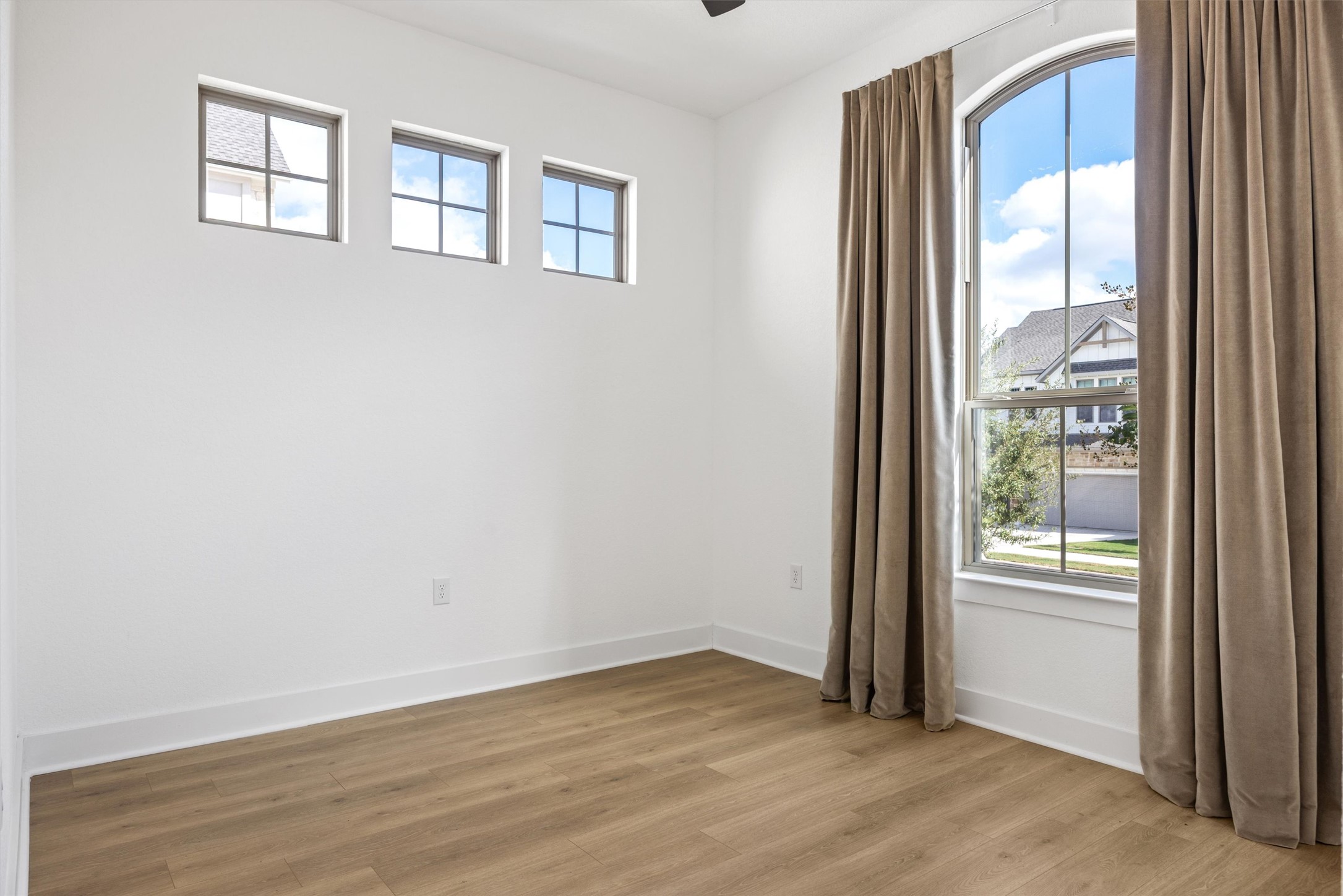 1122 Silver Dollar Trail Georgetown, TX 78628 - Photo 18 of 35 a view of an empty room with wooden floor and a window