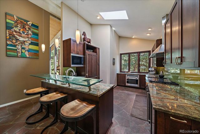 a kitchen with sink and chairs