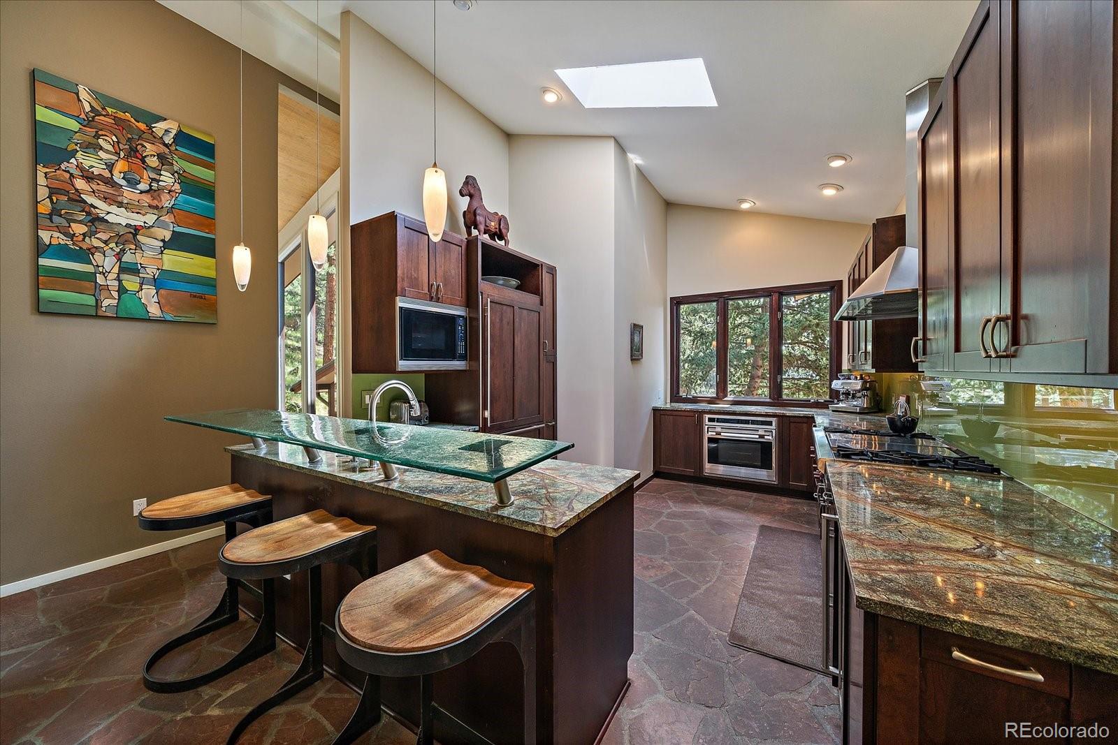 3251 Interlocken Drive Evergreen, CO 80439 - Photo 11 of 43 a kitchen with sink and chairs