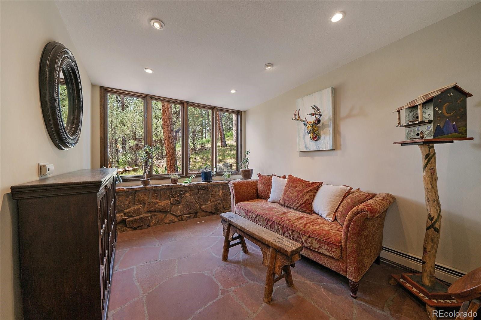 3251 Interlocken Drive Evergreen, CO 80439 - Photo 13 of 43 a living room with furniture and a large window