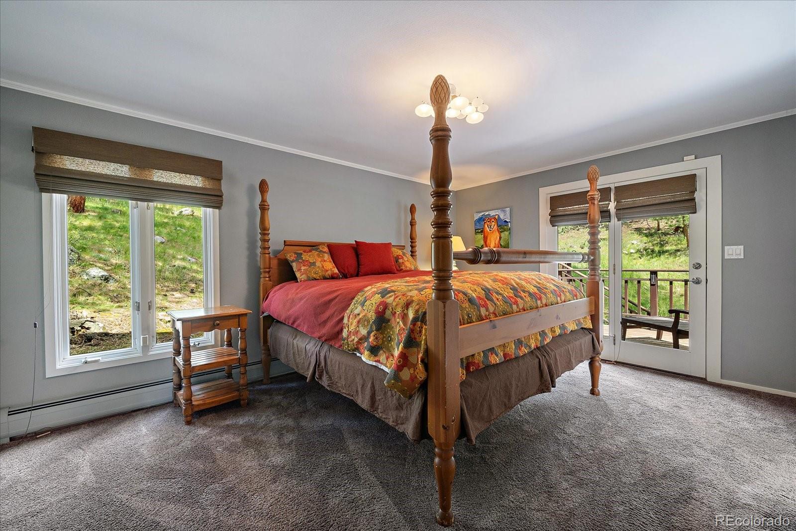 3251 Interlocken Drive Evergreen, CO 80439 - Photo 17 of 43 a bed sitting in a room next to a window