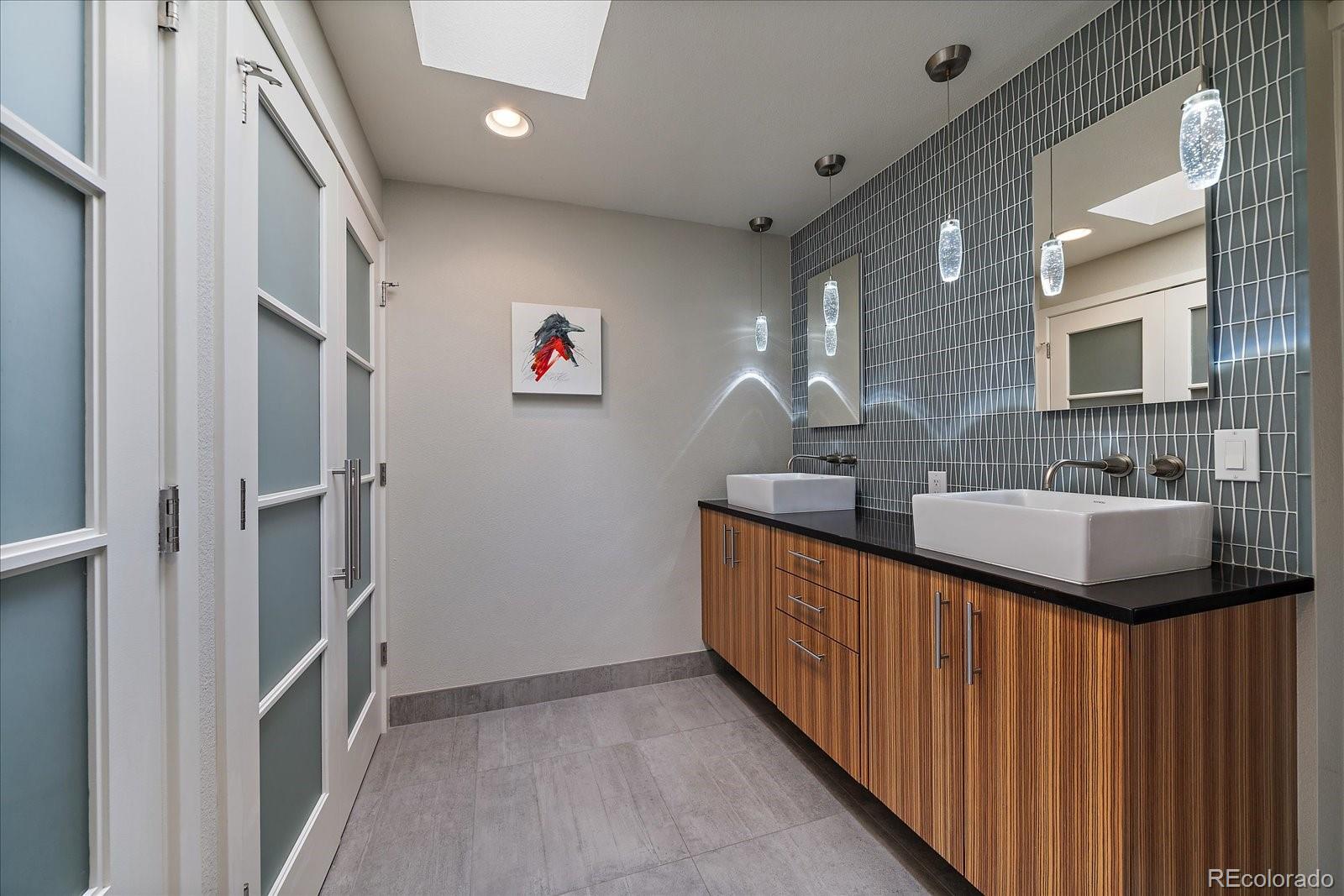 3251 Interlocken Drive Evergreen, CO 80439 - Photo 18 of 43 a bathroom with double vanity and a sink