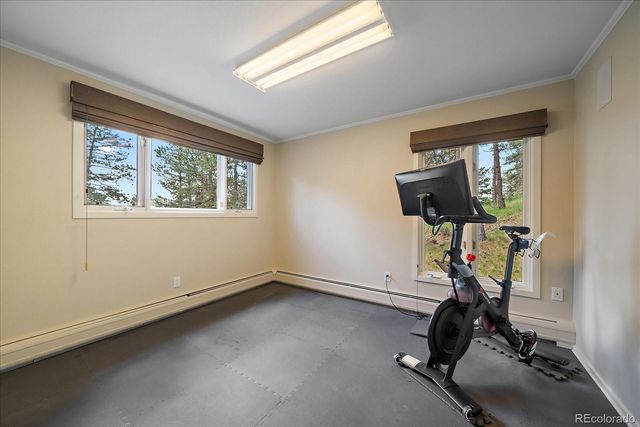 a room with gym equipment and windows