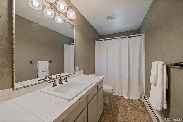 a bathroom with a sink a mirror and a shower