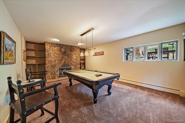 a room with furniture pool table and windows