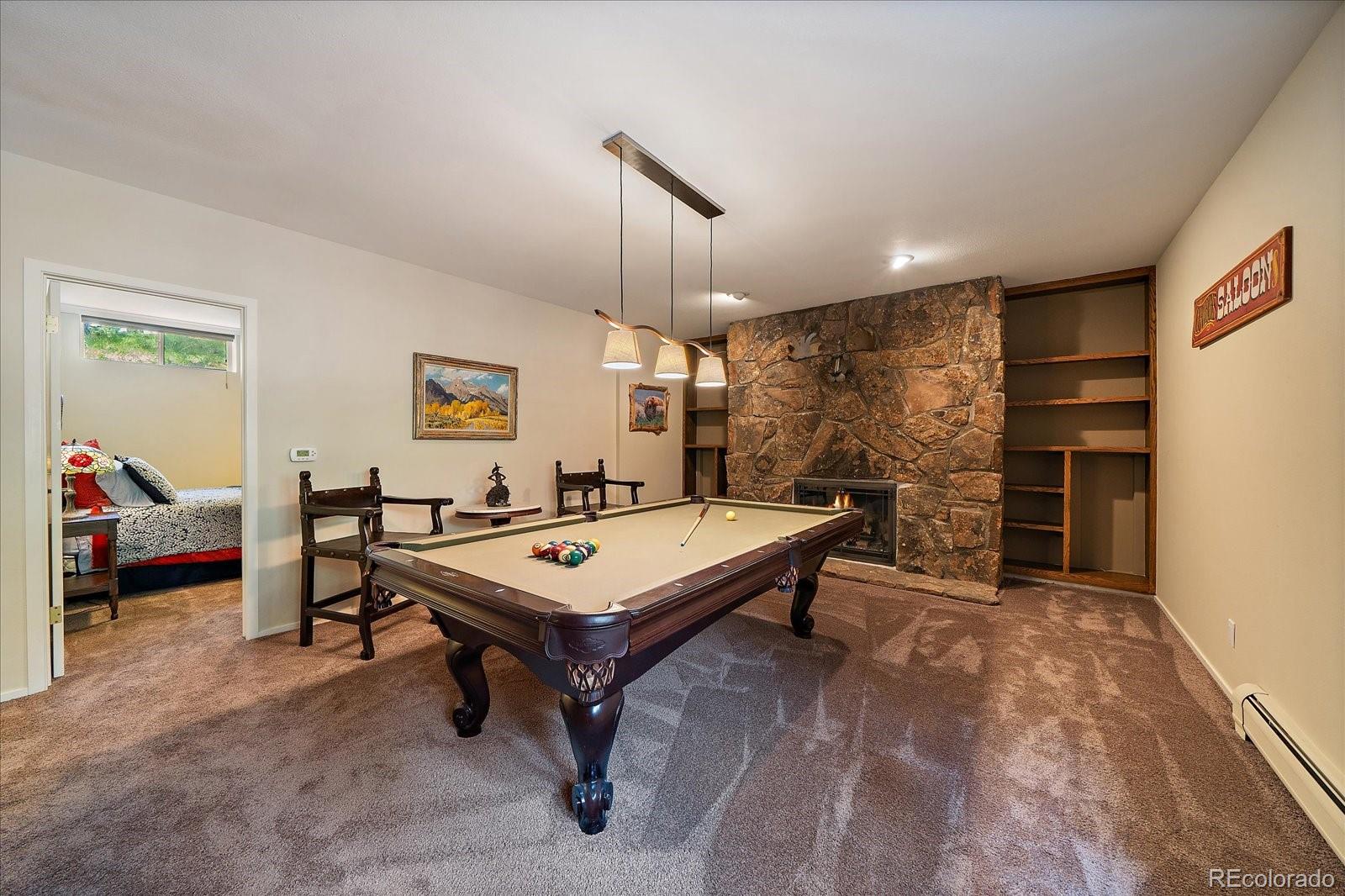 3251 Interlocken Drive Evergreen, CO 80439 - Photo 25 of 43 a living room with furniture a table and a flat screen tv