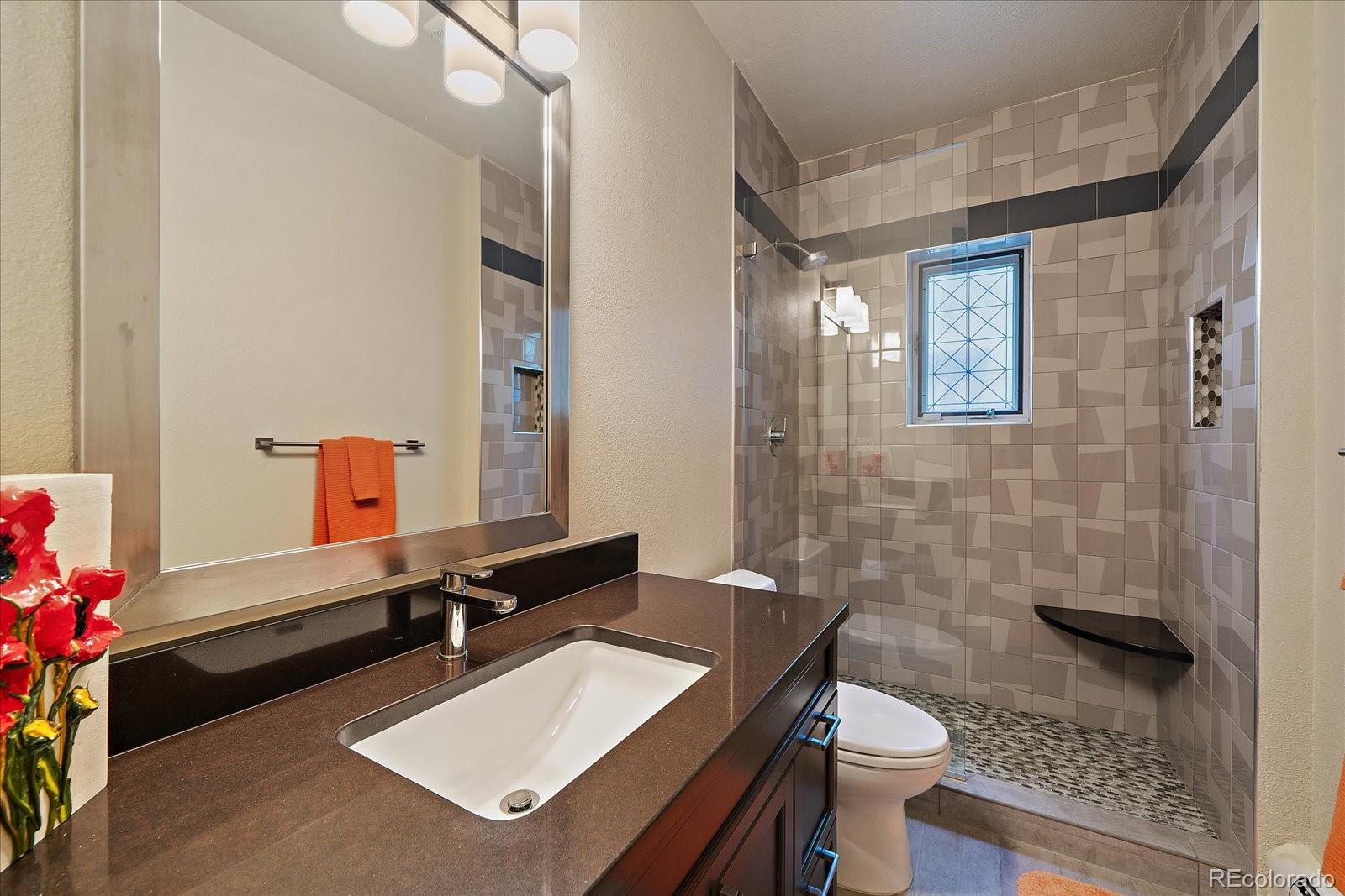 3251 Interlocken Drive Evergreen, CO 80439 - Photo 28 of 43 a bathroom with a sink mirror and a toilet