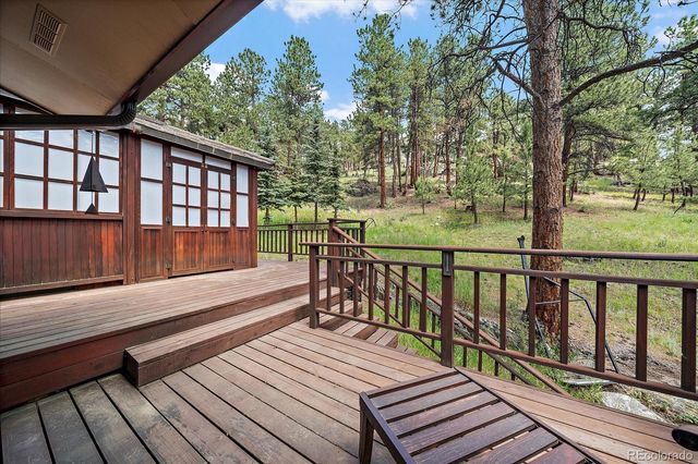 a view of balcony with wooden floor and outdoor seating