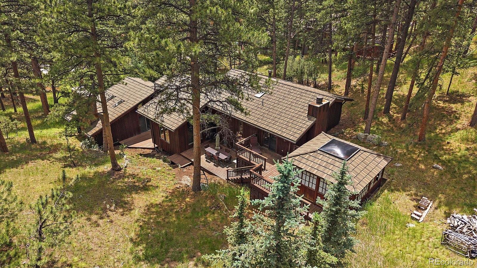 3251 Interlocken Drive Evergreen, CO 80439 - Photo 35 of 43 front view of a house with a yard