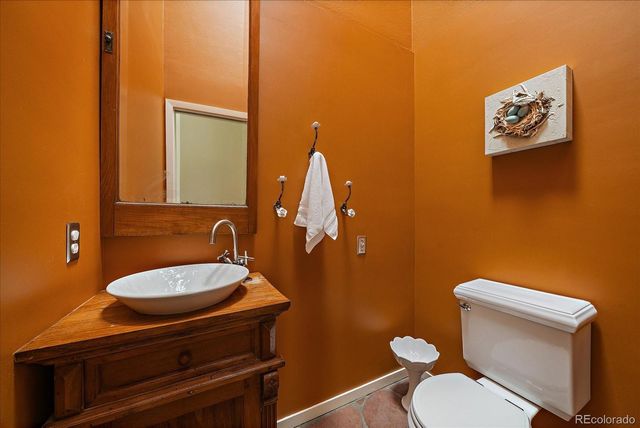 a bathroom with a toilet a sink and mirror