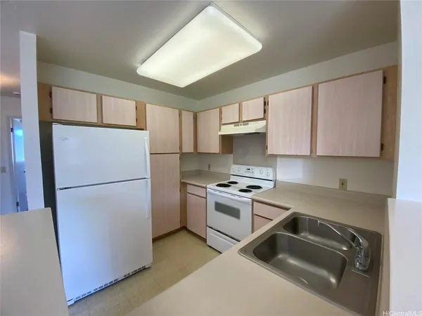 a kitchen with a refrigerator sink stove and cabinets