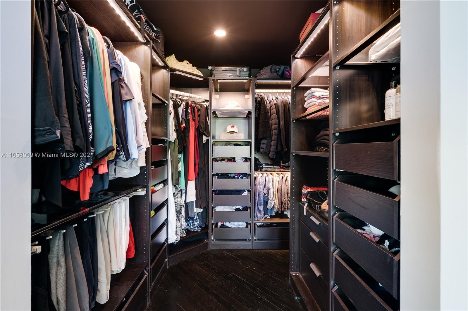 4288 Douglas Road Coconut Grove, FL 33133 - Photo 33 of 69 a view of walk in closet with clothes and shoes