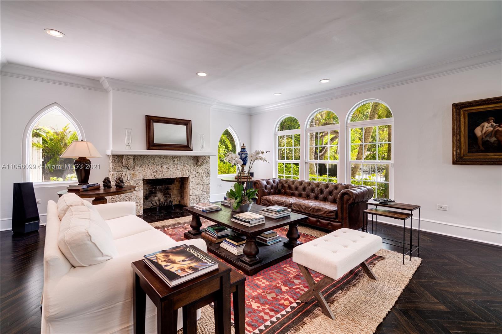 4288 Douglas Road Coconut Grove, FL 33133 - Photo 7 of 69 a living room with furniture a fireplace and a wooden floor