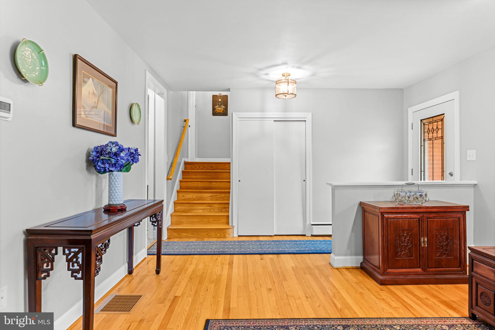 2902 Ritchie Avenue Baltimore, MD 21219 - Photo 9 of 43 a view of a hallway with fireplace and a chandelier