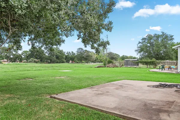 a view of a park and trees in the background