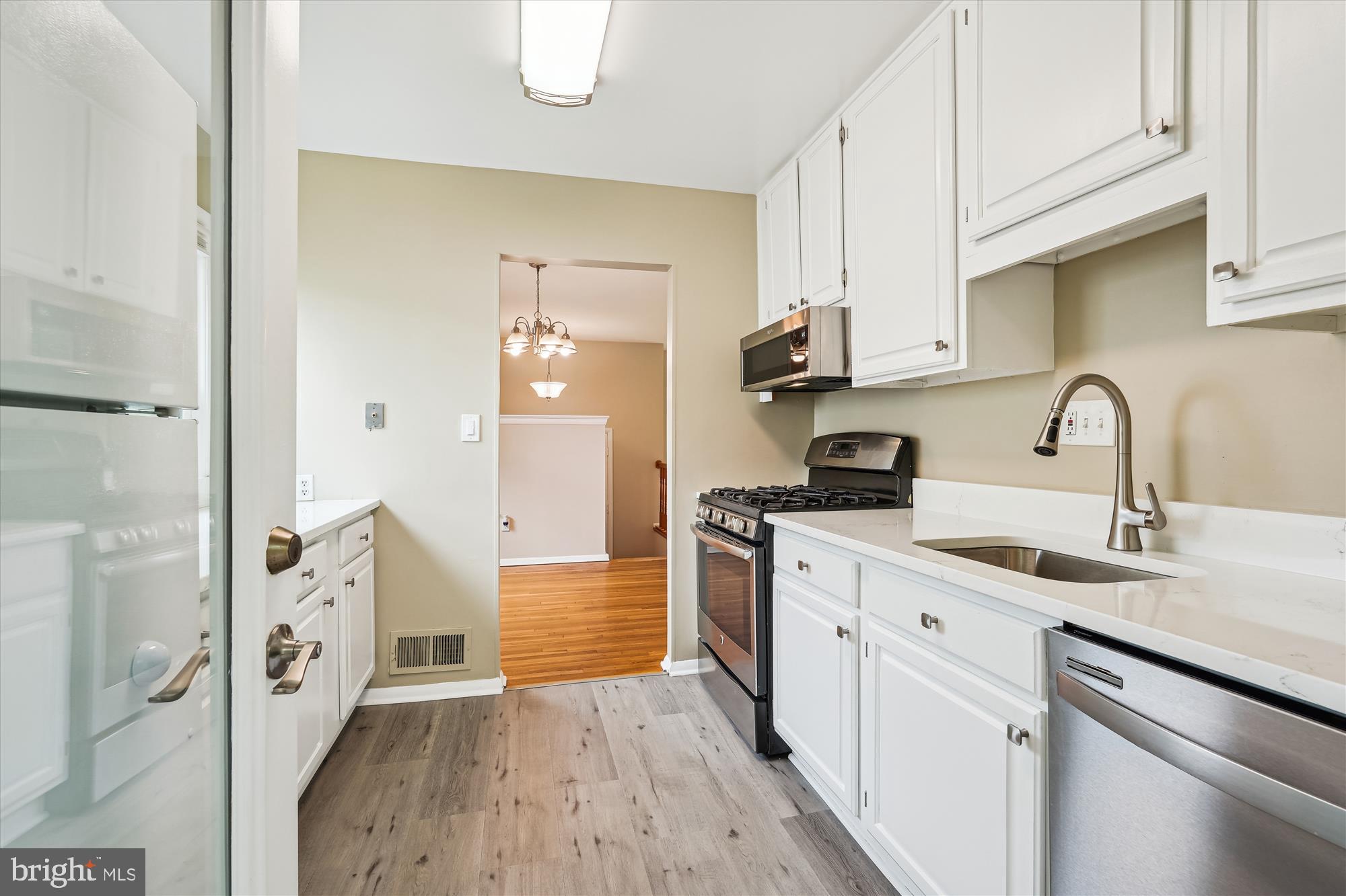 3506 Olympic Street Silver Spring, MD 20906 - Photo 3 of 45 a kitchen with a sink and cabinets