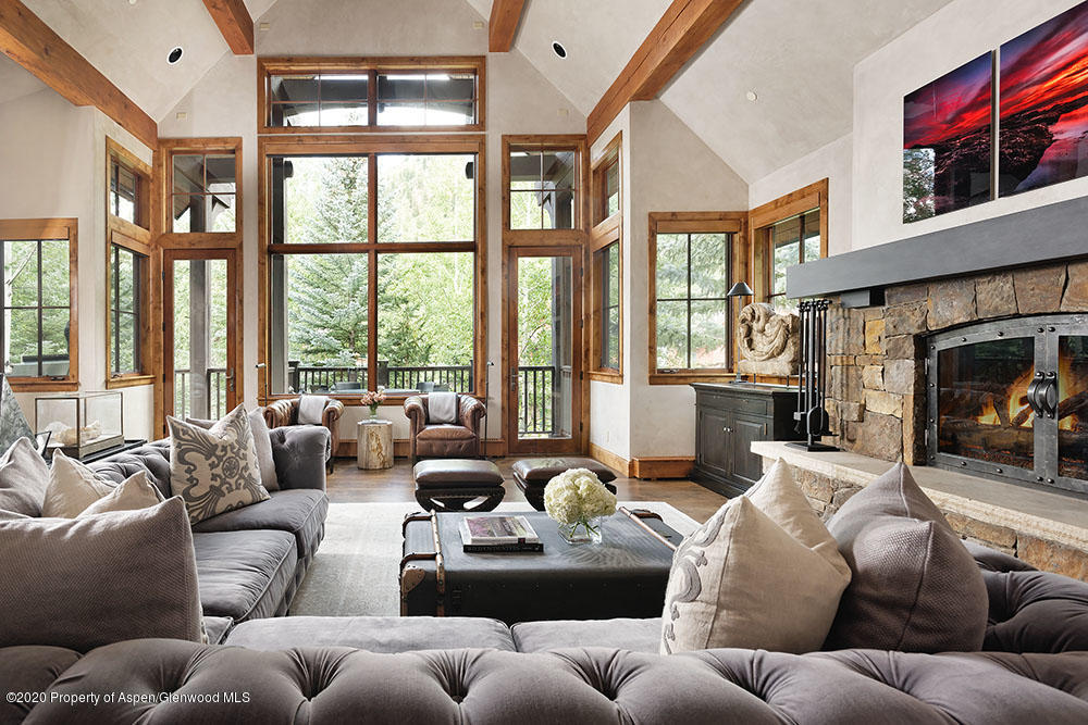 a living room with furniture fireplace and a large window