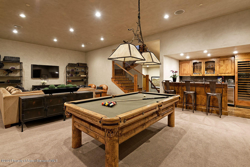 32 Prospector Road Aspen, CO 81611 - Photo 11 of 19 a kitchen with stainless steel appliances a stove a sink a refrigerator cabinets and chairs