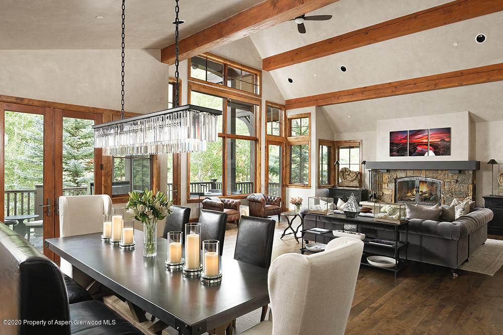 32 Prospector Road Aspen, CO 81611 - Photo 3 of 19 a view of a dining room with furniture large windows and wooden floor