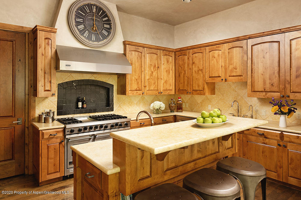 32 Prospector Road Aspen, CO 81611 - Photo 5 of 19 a kitchen with a stove and a table