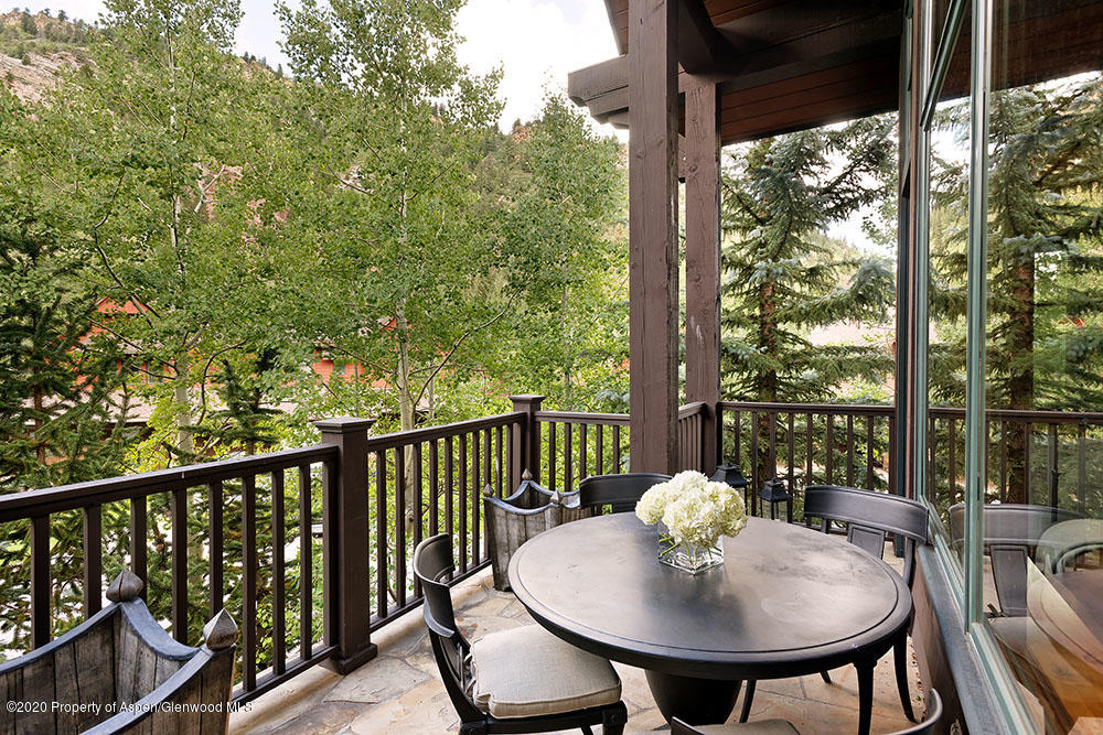 32 Prospector Road Aspen, CO 81611 - Photo 6 of 19 a view of a balcony with table and chairs