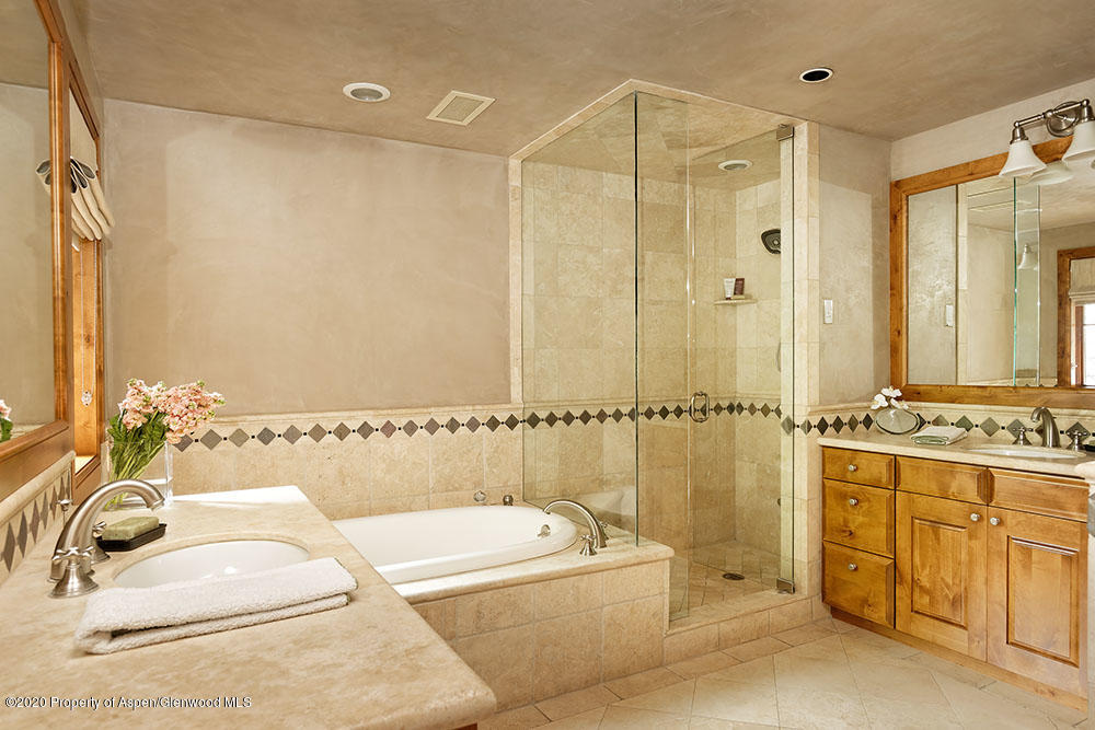 32 Prospector Road Aspen, CO 81611 - Photo 9 of 19 a bathroom with a tub a sink and glass door shower