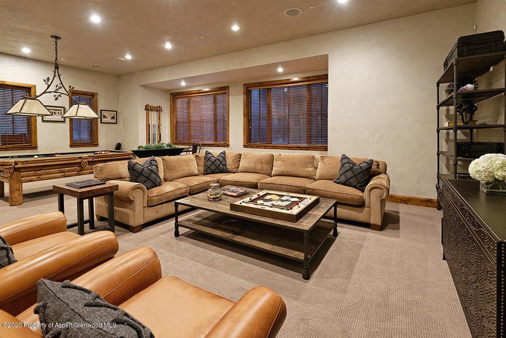 32 Prospector Road Aspen, CO 81611 - Photo 10 of 19 a living room with furniture a rug and a flat screen tv
