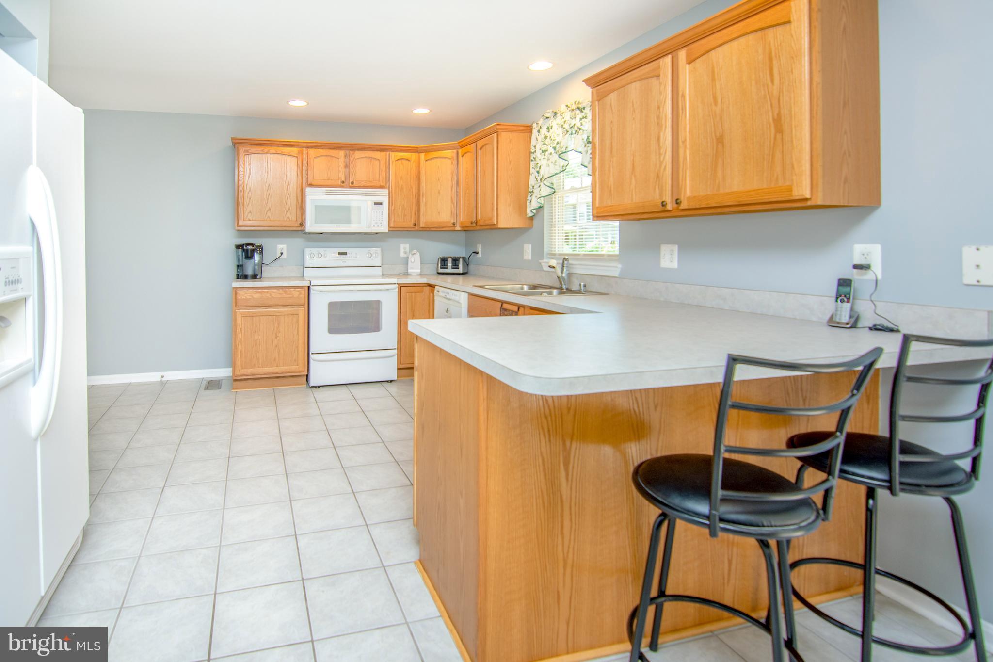 909 Back River Neck Road Baltimore, MD 21221 - Photo 3 of 21 a kitchen with stainless steel appliances granite countertop a stove a sink and a microwave