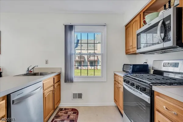 a kitchen with a stove a sink and a microwave