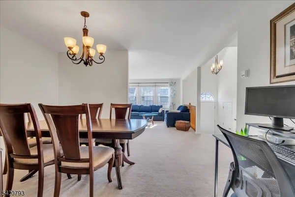 a view of a dining room with furniture and chandelier