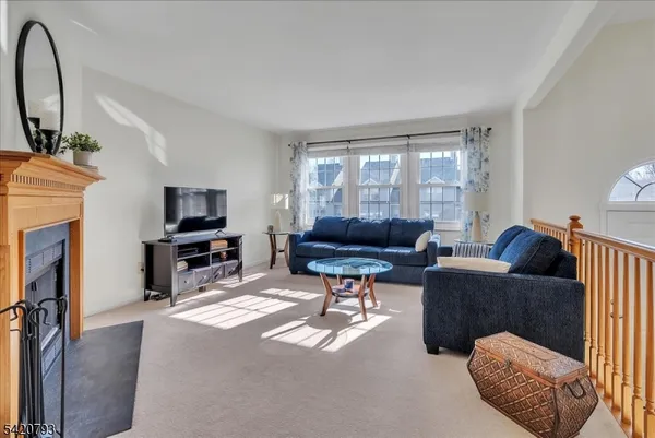 a living room with furniture a window and a flat screen tv
