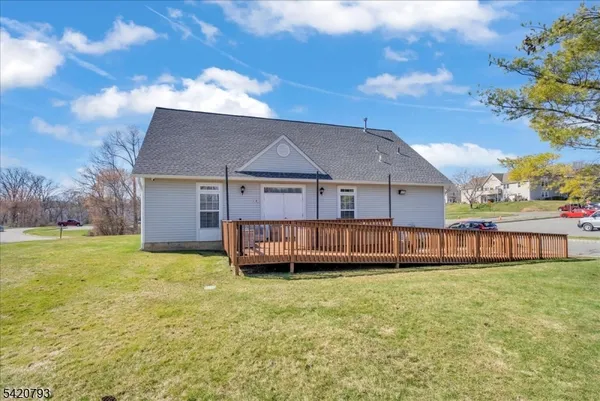 a view of a house with a yard and sitting area