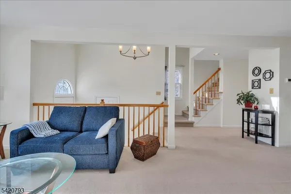 a living room with furniture and stairs