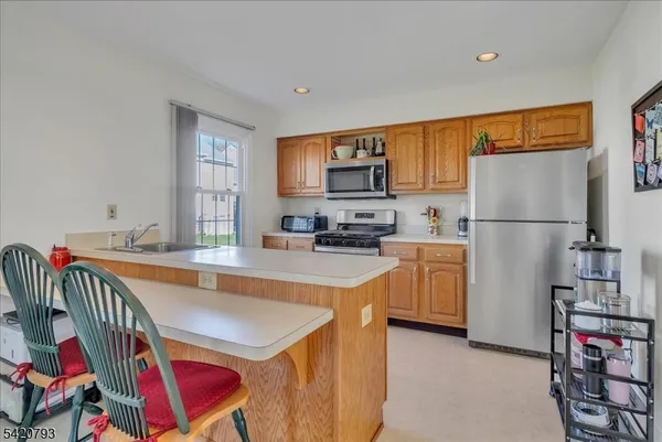 a kitchen with refrigerator and cabinets