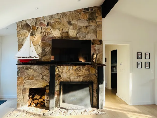 a living room with a fireplace and a flat screen tv