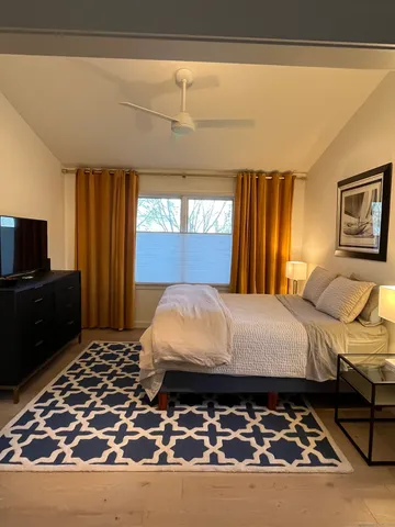 a bed sitting in a bedroom next to a window