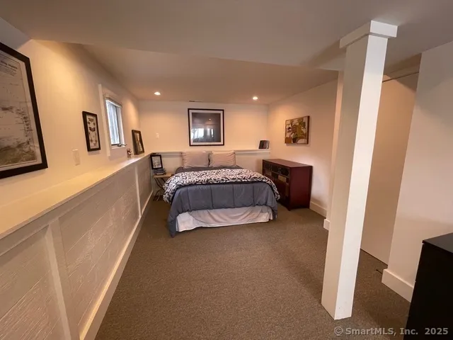 a spacious bedroom with a bed and a desk