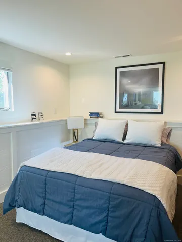 a living room with a couch and dresser