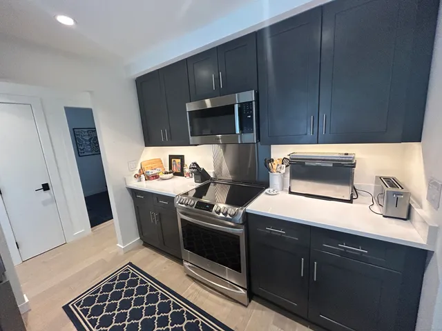 a kitchen with wooden cabinets and a stove top oven