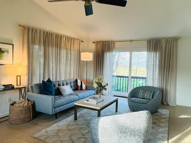 a living room with furniture and a large window