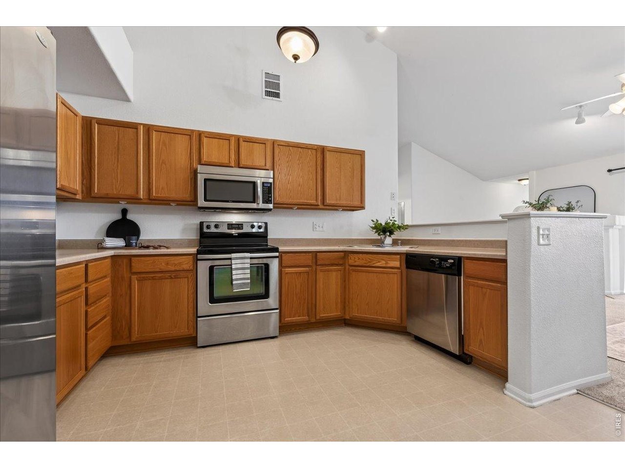 10381 Cook Way, Unit 202 Thornton, CO 80229 - Photo 14 of 38 The kitchen is open, spacious, and ready to make some delicious meals.