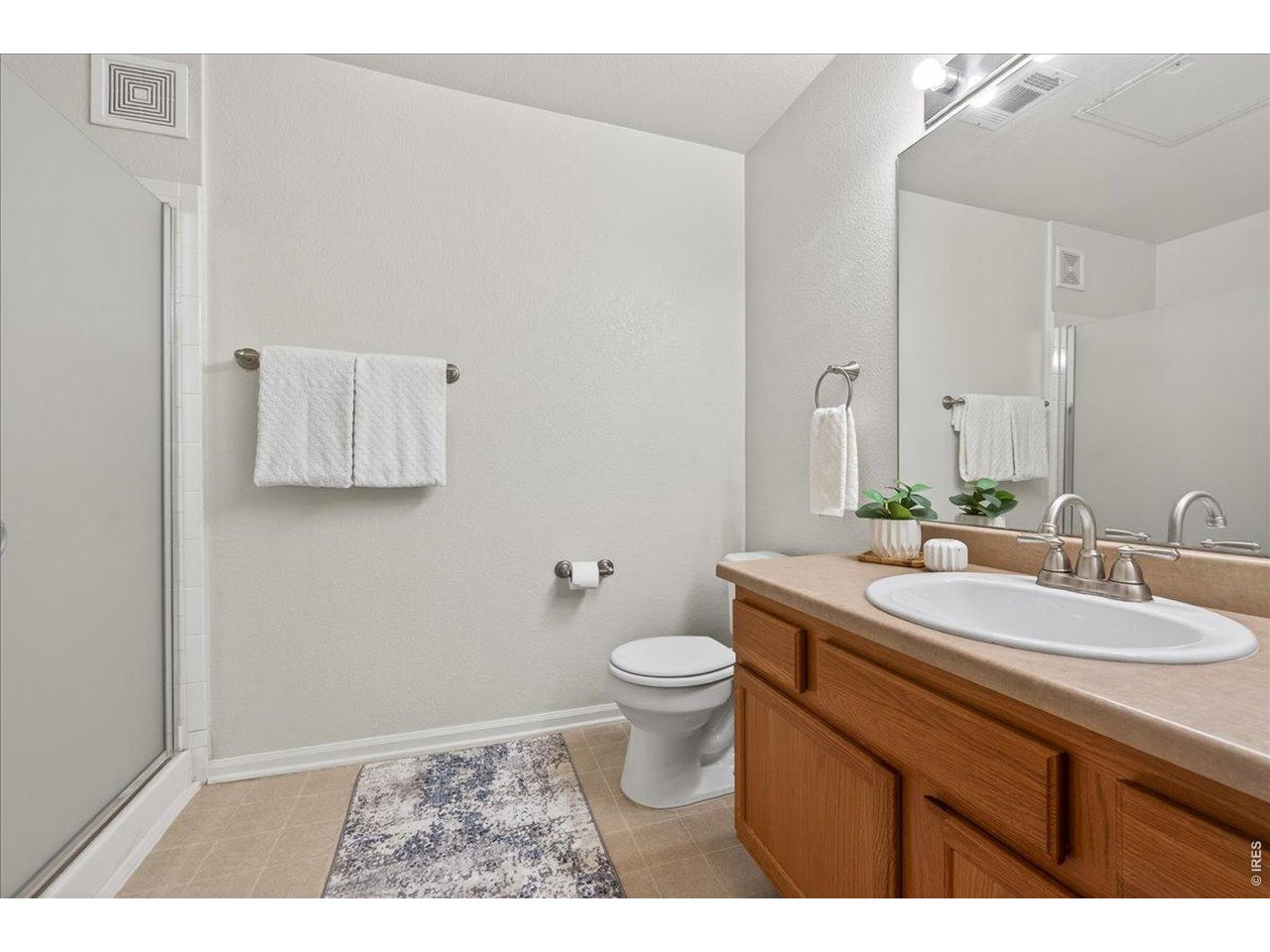 10381 Cook Way, Unit 202 Thornton, CO 80229 - Photo 20 of 38 The 3/4 bathroom is located in the hallway for convenient access.