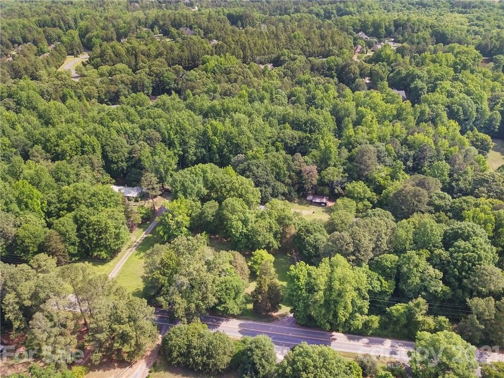 2640 Holbrook Road Fort Mill, SC 29715 - Photo 21 of 24 a view of a house with a lush green forest