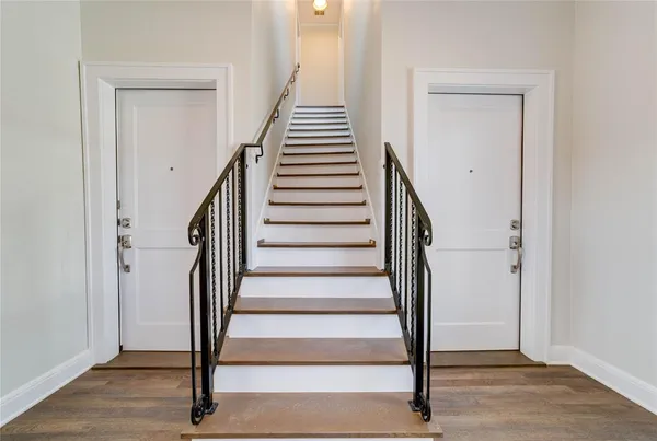 a view of entryway and gallery with wooden floor