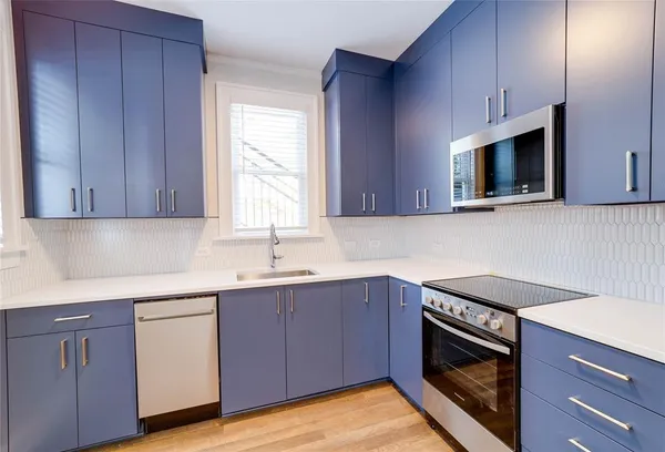 a kitchen with a sink stove and microwave