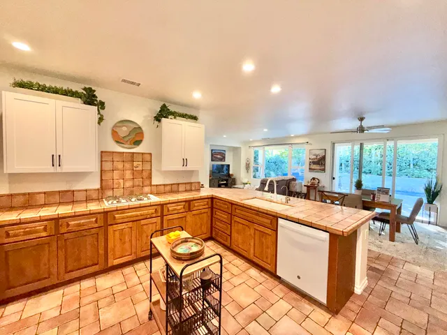 a large kitchen with lots of counter top space and stainless steel appliances