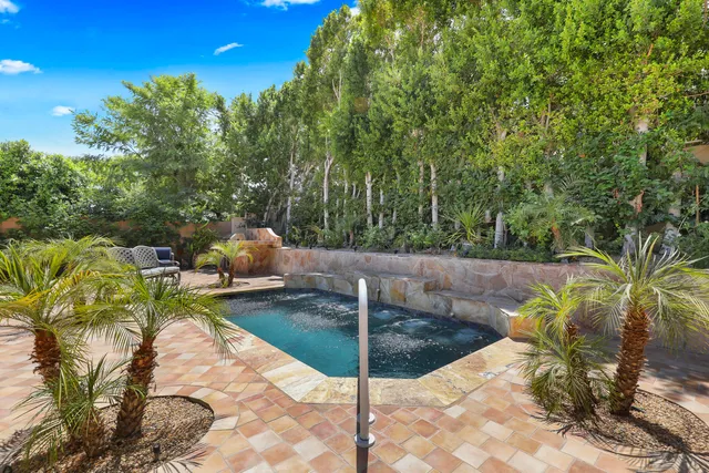 a view of a backyard with plants and patio