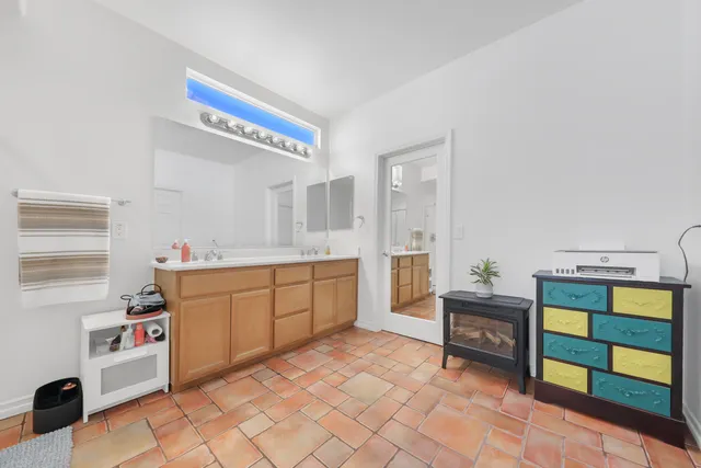 a kitchen with stainless steel appliances cabinets and chair